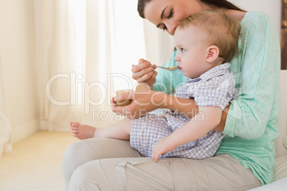 Happy mother eating with her baby boy