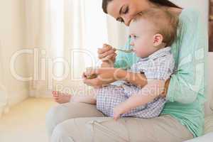 Happy mother eating with her baby boy