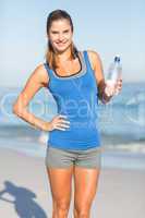 Beautiful fit woman holding water bottle