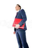 Thoughtful businessman holding red folder