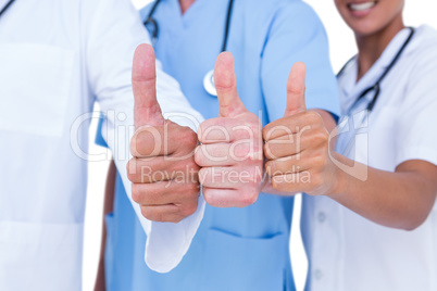 Doctors and nurse gesturing thumbs up