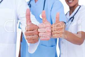 Doctors and nurse gesturing thumbs up