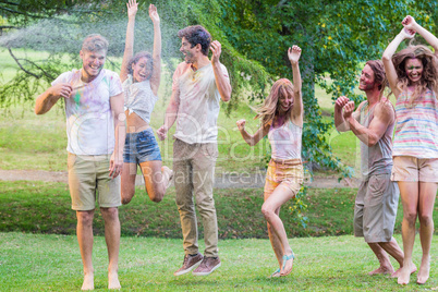 Happy friends covered in powder paint