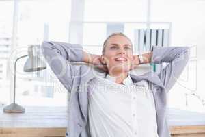 Smiling businesswoman relaxing on her office