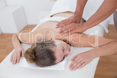 Physiotherapist doing arm massage to his patient