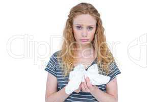 Sick blonde woman holding paper tissue