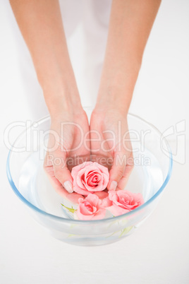 Woman enjoying a hand treatment in a bowl