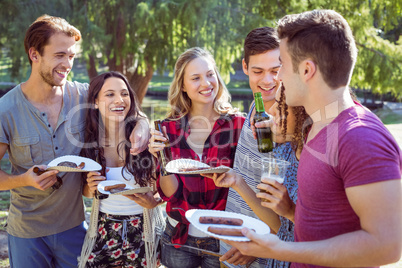 Happy friends in the park having picnic