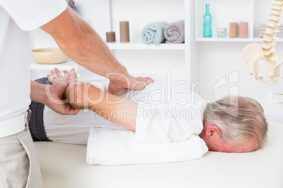 Physiotherapist doing back massage to his patient