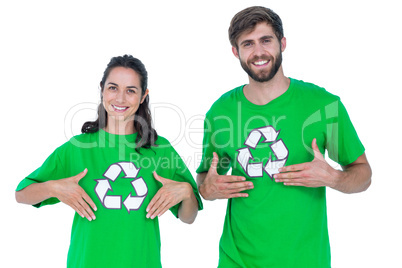 Friends wearing recycling tshirts pointing themselves
