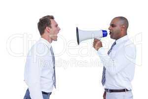 Businessman yelling with a megaphone at his colleague
