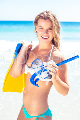 Happy pretty blonde holding mask, scuba and fins