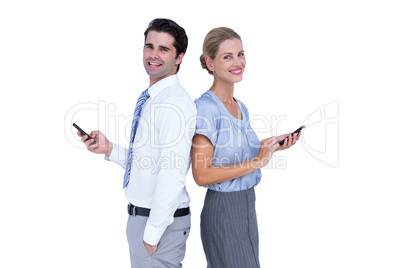 Business people using smartphone back to back