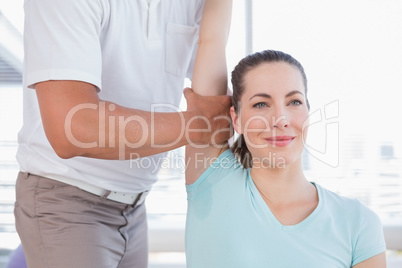 Woman stretching her arm with trainer