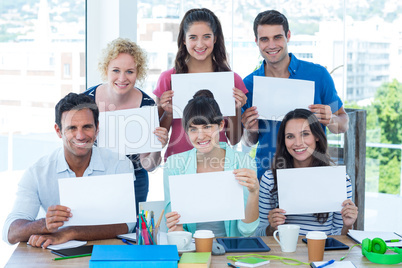 Creative business team holding a signboard