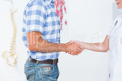 Patient shaking hands with doctor