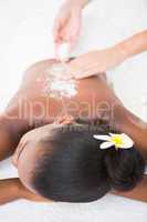 Pretty woman enjoying an exfoliation massage