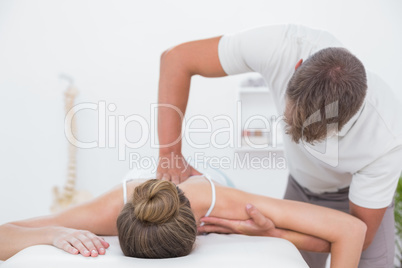 Physiotherapist doing back massage to his patient Physiotherapist doing back massage to his patient