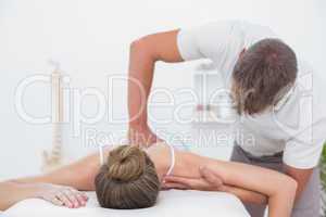 Physiotherapist doing back massage to his patient