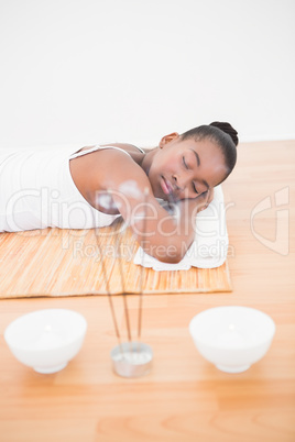 Peaceful pretty woman lying a bamboo mat