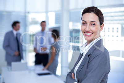 Smiling businesswoman with arms crossed