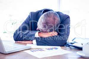Businessman resting head on desk
