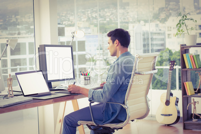 Casual businessman using computer in office