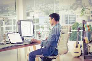 Casual businessman using computer in office