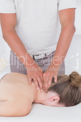 Physiotherapist doing neck massage to his patient