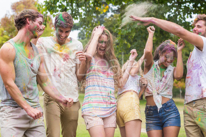 Happy friends throwing powder paint