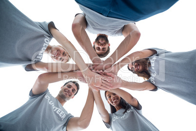 Volunteers putting their hands together