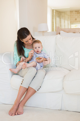 Happy mother eating with her baby boy