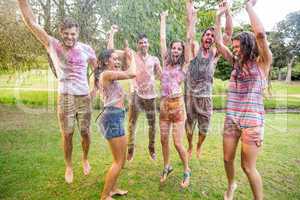 Happy friends jumping in the water shoot