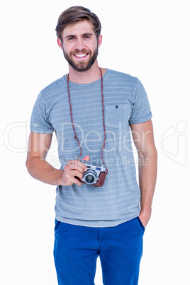 Happy handsome man looking at camera and holding photo camera