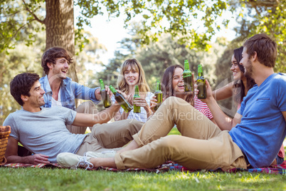 Happy friends in the park having picnic