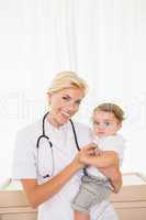 Portrait of a smiling blonde doctor and child