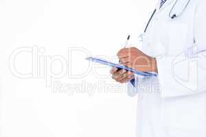 Standing doctor in white tunic writing notes