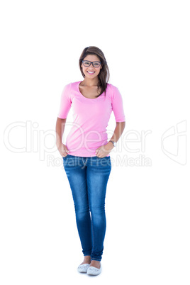 Pretty brunette wearing glasses with hands in pocket