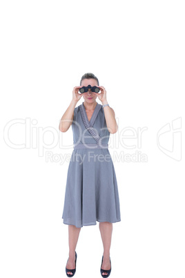 A businesswoman looking through binoculars