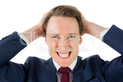 Nervous businessman looking at camera with hand on head