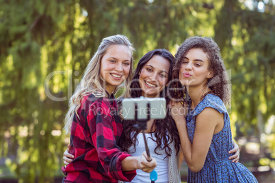Happy hipster staking a selfie in the park