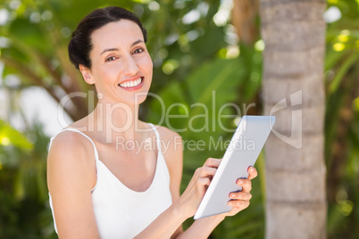 woman in white using her phone