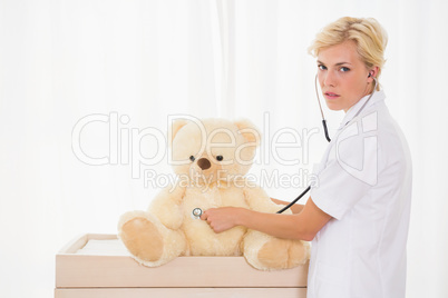 Blonde doctor with bear and stethoscope