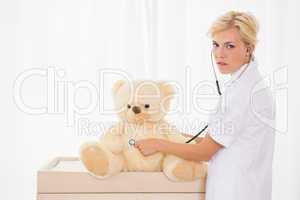 Blonde doctor with bear and stethoscope