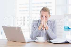 Frustrated businesswoman with head in hands