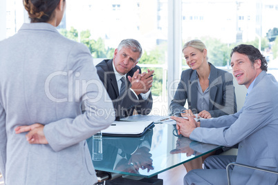 Businesswoman with fingers crossed behind her back