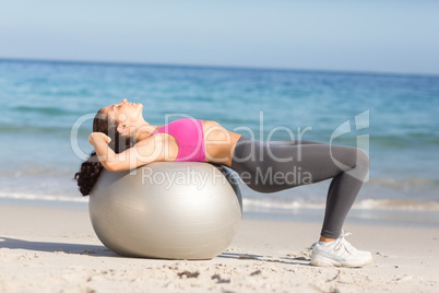 Fit woman stretching on exercise ball