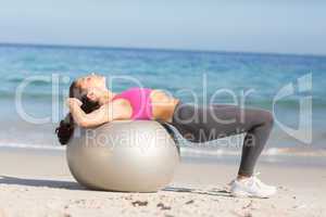 Fit woman stretching on exercise ball