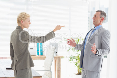 Businesswoman giving out to her boss