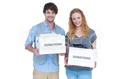 Smiling young couple carrying donation box